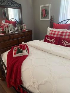 a bedroom decorated for christmas with red and white decor