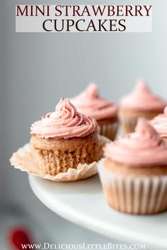 mini strawberry cupcakes with pink frosting on a white cake platter and text overlay