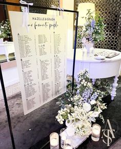 a table with flowers and candles on it next to a sign that says hotel room rules