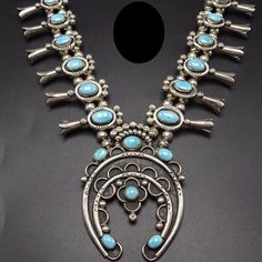 "VINTAGE NAVAJO SQUASH BLOSSOM NECKLACE DESCRIPTION: This impressive necklace features gorgeous bright blue specimens of clear, light blue Sleeping Beauty turquoise. The gemstones are secure in sawtooth bezel, on a foundation of heavy gauge vintage sterling silver. Hand stamped raindrops punctuate the blossoms and crown the naja. This magnificent necklace will be a valuable addition to your collection of fine vintage Native American jewelry. MEASUREMENTS: Necklace measures 29\" end to end Naja m Vintage Squash Blossom Necklace, Turquoise Squash Blossom, Vintage Native American Jewelry, Silver Turquoise Jewelry, Squash Blossom Necklace, Squash Blossom, Sleeping Beauty Turquoise, Vintage Navajo, Wedding Jewellery Necklace