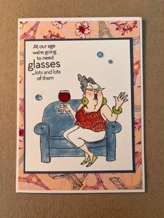 a card with an image of a woman sitting on a couch holding a glass of wine