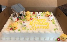 a birthday cake in a box with some animals on it