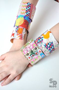 a child's arm with two colorful bracelets on it