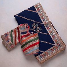 two pieces of cloth are laying on the floor next to each other, with beads and bead work