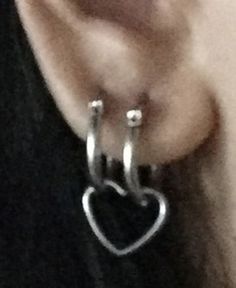 an earring with a heart hanging from it