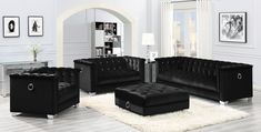 a living room filled with black furniture and white rugs