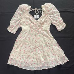 Light Creme And Pink Floral Mini Dress, It Has A Surplice Neckline, Open Back With Self-Tie Support Strap, 3/4 Puff Sleeves, Ruching At The Waist And Back Panel, Ruffled Trim, A Tiered Hem, And Concealed Back Zipper For Size, The L Fits More Like A M And The Xl Fits More Like A L Feminine Tiered Mini Dress For Spring, Forever 21 Floral Print Mini Dress For Brunch, Forever 21 Ruffled Mini Dress, Forever 21 Ruffled Mini Dress For Spring, Spring Ruffle Mini Dress By Forever 21, Forever 21 Feminine Mini Dress For Spring, Spring Ruffled Mini Dress By Forever 21, Forever 21 Mini Dress For Spring Brunch, Forever 21 Pink Dress For Spring