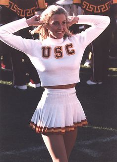 a woman in a cheerleader uniform posing for a photo