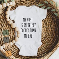 Let your little one rock this hilarious onesie and show off their cool aunt! This funny baby onesie adds a touch of humour to any outfit while keeping your baby comfy. Perfect for family gatherings, playdates, or just lounging at home (and maybe poking fun at dad). Details:Our cotton bodysuits are customised using labels cut from high quality transfer film. Care Instructions: Gentle cold wash cycle only. Handwash where possible. Please note - It is recommended that you gently hand wash only to preserve your new product. Soaking in hot water, scrubbing and usage in dryers can damage the product.Product Processing Timelines: 3-5 DaysWant to add something else? Get in touch with us at hello@creationsbyjulietta.com.au and we can see if we can accommodate your request. Cricut Onesie Ideas, Auntie Onsies For Babies, Aunt Onsies, Cool Aunt Onesie, Cricut Onsies, Aunt Onesie I Can't Even Shirts, Aunt Onesie Girl