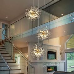 a living room filled with furniture and a fire place next to a stair case in front of a window