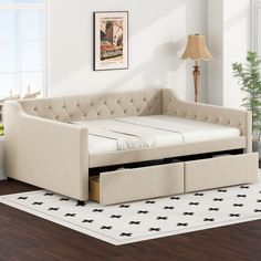 a day bed with pull out trundle and storage underneath it in a living room