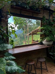 an open window with plants and stools in front of it