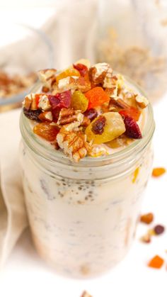 a glass jar filled with granola and fruit