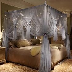 a canopy bed with lights on it in a bedroom