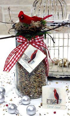 a bird is sitting on top of a jar filled with birdseed and two cards