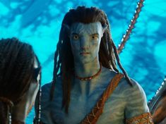 two people with dreadlocks standing next to each other in front of a blue background