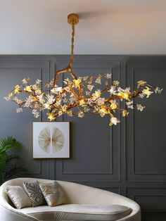 a living room with a couch and a chandelier hanging from it's ceiling