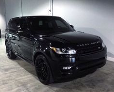 a black range rover parked in a garage