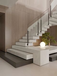 a modern staircase with glass railings and white steps leading up to the second floor