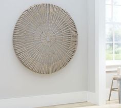 a white room with a round metal wall decoration