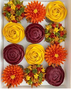 cupcakes decorated with flowers in a box