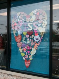 a store window that has been decorated with stickers and letters on it's side