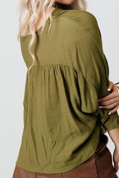 You and this darling green shift top were made for each other with its lightweight material, a button up front with a rounded neckline, long loose sleeves with tie closure cuffs, and a relaxed silhouette that falls into a straight hemline! Green Button-up Solid Color Top, Oversized Green Blouse For Day Out, Green Solid Color Button-up Top, Casual Long Sleeve Top With Tie Sleeves, Casual Button-up Peasant Top For Fall, Oversized Green Tops For Daywear, Green Oversized Tops For Daywear, Green Blouse With Roll-up Sleeves For Spring, Long Sleeve Summer Peasant Top For Workwear