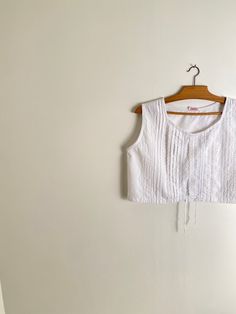 "Vintage white cotton pin tuck blouse with crew neck collar. Lovely cropped oversized fit. Unlined. Materials: cotton Condition: very good vintage condition Size: M on the tag, estimated to fit s frames Measurements: shoulders: 38 cm or 15\" bust: 51 cm or 20.1\" waist: 51 cm or 20.1\" length: 39 cm or 15.3\" Measurements are taken seam to seam while lying flat Follow this link to see all the tops available in the shop: https://www.etsy.com/fr/shop/peneloppevintage?ref=shop_sugg&section_id=21637 Pin Tuck Blouse, Vintage Sleeveless Cotton Crop Top, Vintage White Crop Top, Vintage White Summer Crop Top, Vintage White Crop Top For Spring, Vintage White Crop Top For Summer, White Vintage Crop Top For Summer, Vintage Cotton Crop Top For Spring, Cropped Cotton Crop Top For Daywear