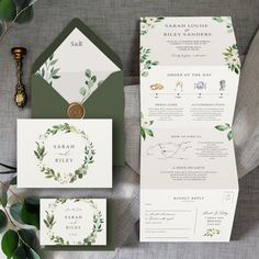 the wedding stationery is shown with green and white flowers on it, along with an envelope