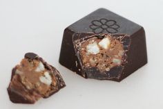 two pieces of chocolate sitting next to each other