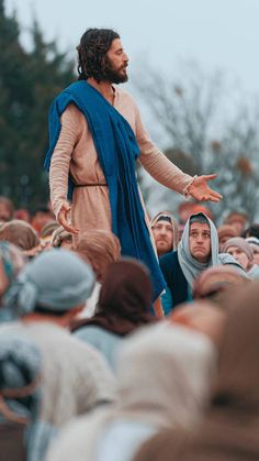 a man dressed as jesus speaking to a group of people