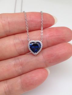 925 Sterling Silver Cz Sapphire Heart Halo Pendant Necklace   - Metal: 925 Sterling Silver (Finish: Rhodium Plated) - Stone: Clear Cubic Zirconia/Lab-Created Blue Sapphire, Round/Heart Cut,                 Prong/Pave - Shape: Heart - Pendant Dimension: Height 10mm(0.39 in) x Width 9.8mm(0.385 in), Thickness 5mm/3mm. (Please note that center sapphire heart is 8mm x 7.8mm, Tiny.) - Light Cable Chain: 17.5" Adjustable (15.5" + 1" + 1"), Lobster Clasp - Color: Silver Sapphire Cubic Zirconia Jewelry For Valentine's Day, Valentine's Day Sapphire Cubic Zirconia Jewelry, Heart-shaped Lab-created Sapphire Jewelry For Valentine's Day, Valentine's Day Heart-shaped Lab-created Sapphire Jewelry, Elegant Jewelry With Lab-created Sapphire For Valentine's Day, Elegant Lab-created Sapphire Jewelry For Valentine's Day, Blue Lab-created Sapphire Jewelry For Valentine's Day, Heart Cut Lab-created Sapphire Jewelry Gift, Blue Heart Necklace