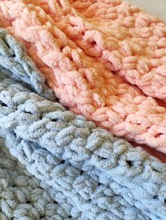 three crocheted blankets laying on top of each other