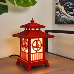 a red lantern sitting on top of a wooden table