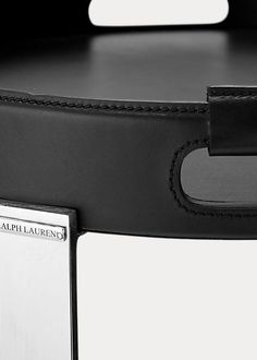 a close up of a black and white suitcase with a name tag on the handle