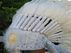 Medium Indian Headdress Replica made with white rooster feathers and cream stone in the front This great adult headdress is entirely handmade and truly adorable. Perfect photography prop for your special ocasion. Ties in the back for a perfect fit. This will be precious for your costume, or even room decor. Head circumference: 59 centimeters / 23 inches ✈️ Worldwide shipping 🐤 I only use authentic feathers ⛺️ I guarantee highest quality, 100% hand-crafted White Ostrich Feather Headpiece With Feather Trim, White Bohemian Ceremonial Headpiece, Ceremonial White Handmade Headpieces, Handmade White Headpieces For Ceremonial Events, Ceremonial Handmade White Headpiece, Fringe Wedding Dress, Cream Stone, Black Rooster, Indian Headdress