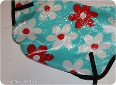 a blue and white bag with red flowers on it