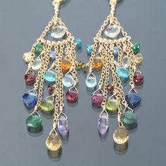 "I handmade these dazzling chandelier earrings with a rainbow of colorful gemstones: tourmaline, kyanite, garnet, blue topaz, peridot, emerald, apatite, citrine, amethyst, lemon topaz, tanzanite, and scapolite! These one of a kind earrings are glamorous, captivating, and eye-catching! They're fabulous to wear for special events, soirees, date nights or simply relaxing in tie-dye leisurewear :) The faceted AAA natural stone briolettes are wire wrapped to gold-filled chain, and the earrings measur Colorful Gold Earrings, Handmade Chandelier Earrings, Chandelier Earrings Diy, Earrings Handmade Beaded, Colorful Gemstones, Earrings Inspiration, Work Jewelry, Bead Jewellery