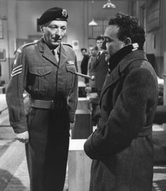 two men in uniforms talking to each other