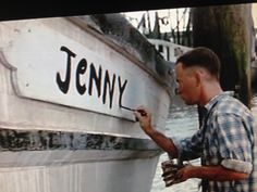 a man writing on the side of a boat