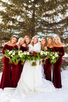 a group of women standing next to each other in the snow