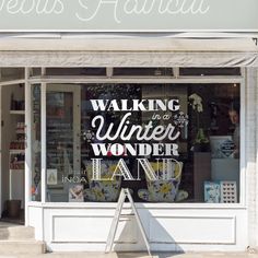 a window display with the words walking in a winter wonderland painted on it