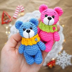 two small crocheted teddy bears sitting next to each other