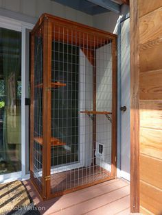 an open door on the outside of a house with wood siding and glass doors,