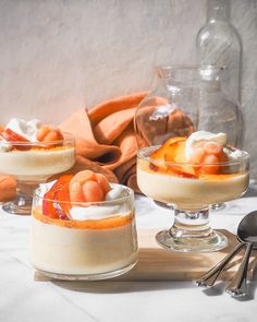 three desserts are sitting on a table with spoons