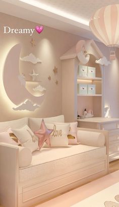 a room with a white couch and some pink pillows