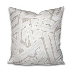 a white pillow with an abstract design on it