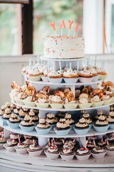 a cake and cupcakes are stacked on top of each other