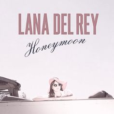 a woman wearing sunglasses and a pink hat laying on top of a boat with the words honeymoon written above her