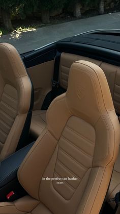 the interior of a car with tan leather and black stitching on the front seats